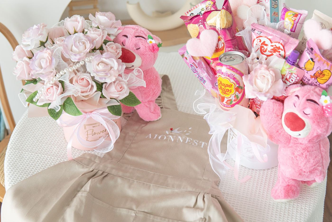 Pink rose bouquet and snack bouquet next to the AionNest apron